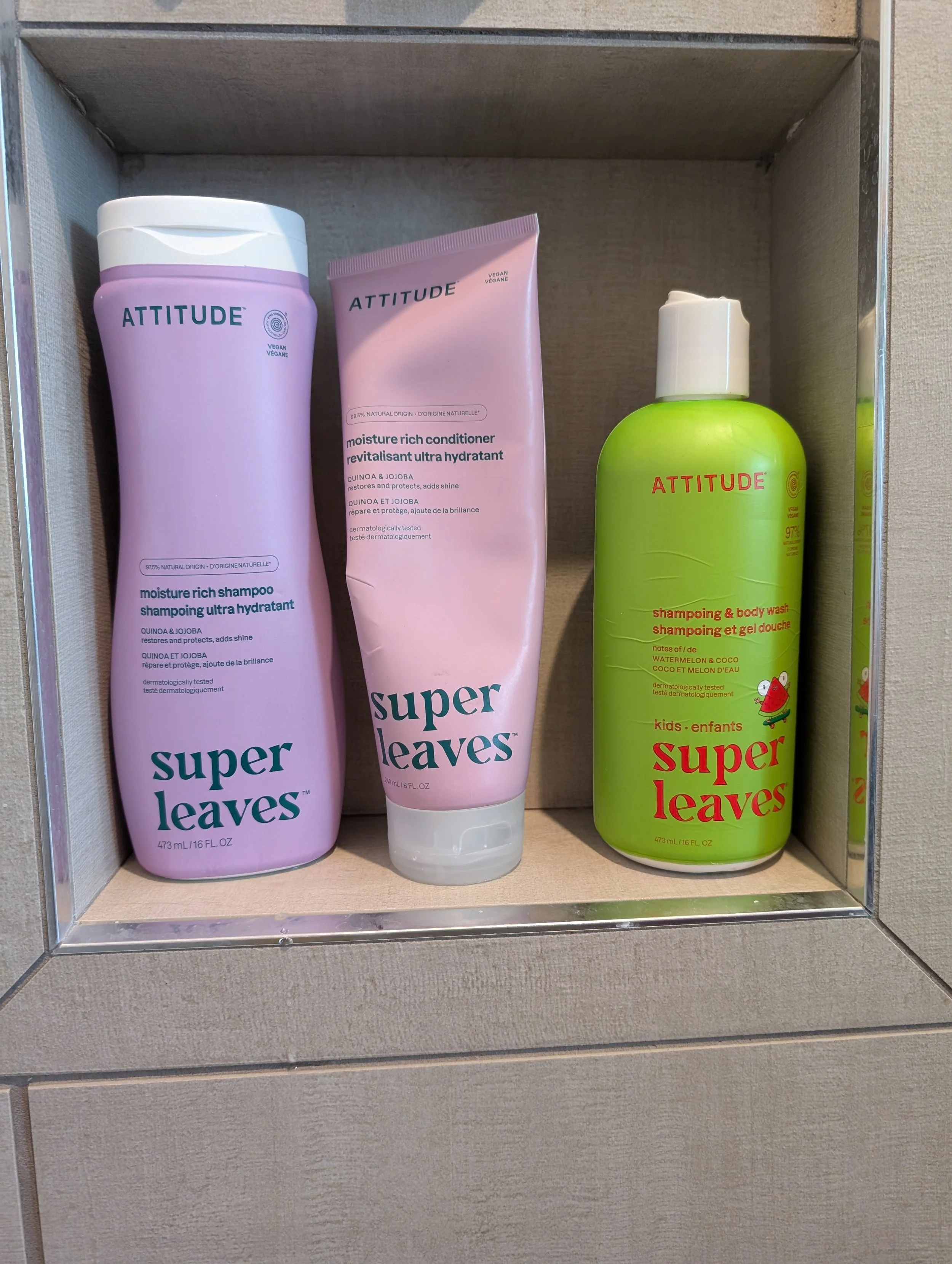 Purple and Green Shampoo and Soap bottles