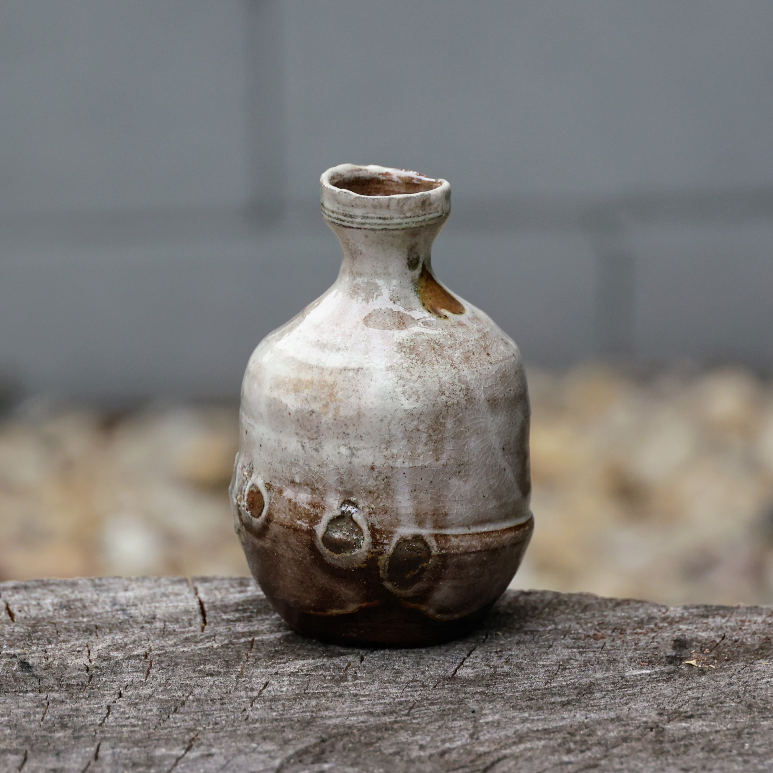 Sake bottle from the Kegonsa anagama. 

The finger marks, left after pouring glaze over my hand while holding the piece, are something I don't do very often. I have mixed feelings about them. On one hand (pun intended!), finger marks memorialize my r