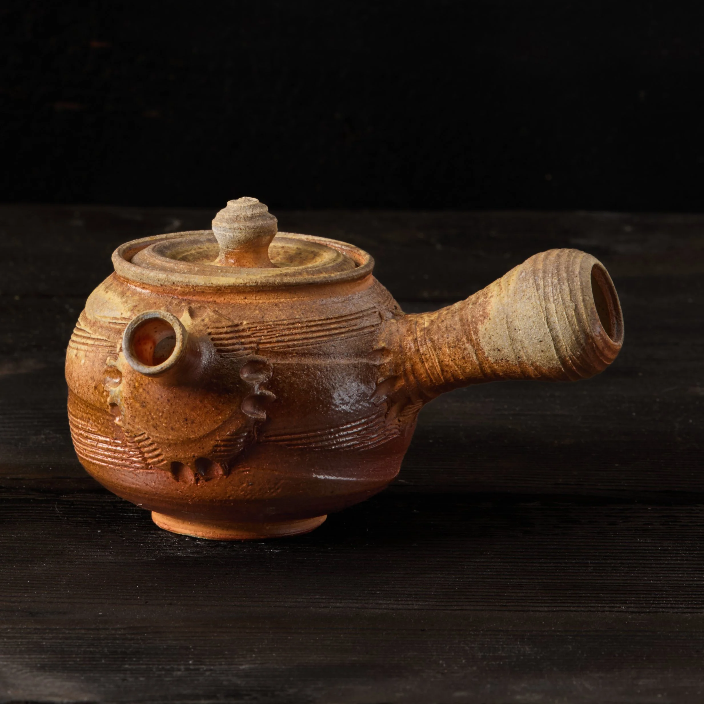 Kyusu teapot. Stoneware with natural ash glaze and shino liner. 

This pot was loaded near a stoke hole in David Smith's Kegonsa Anagama, and I remember getting little glimpses of it throughout that firing last May. It was interesting to watch the as
