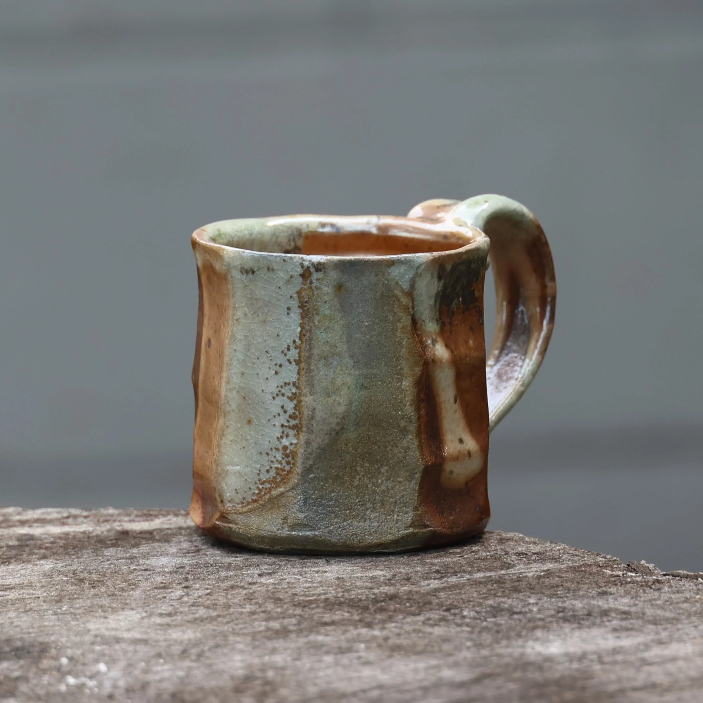 Stoneware mug with shino and natural ash glaze from a firing at home in early August. 

I held this mug back from the recent mug show because I might have to keep it. Slide 4 is a zoom-in on the good spot. Kiln magic. 

#woodisgood #woodfired #potter