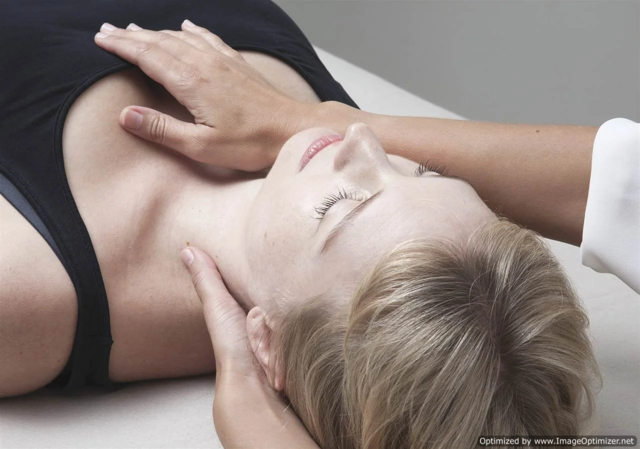 pregnant woman receiving gentle cranio sacral treatment treatment