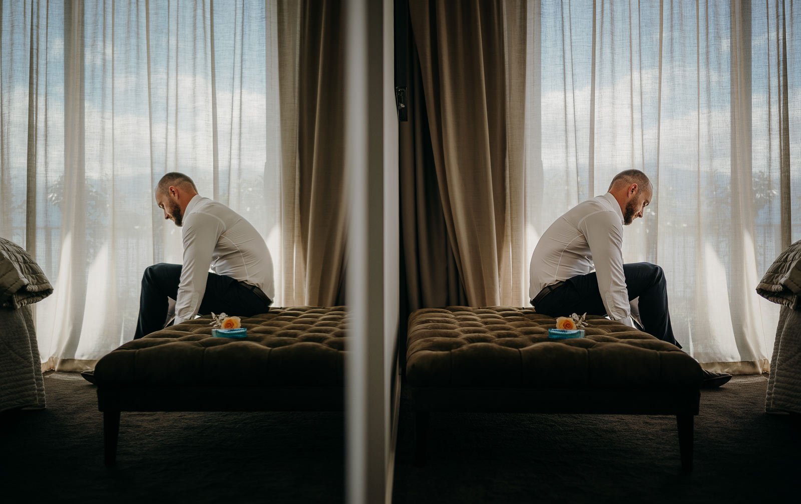 reflection of groom putting on his wedding shoes before his Queenstown elopement