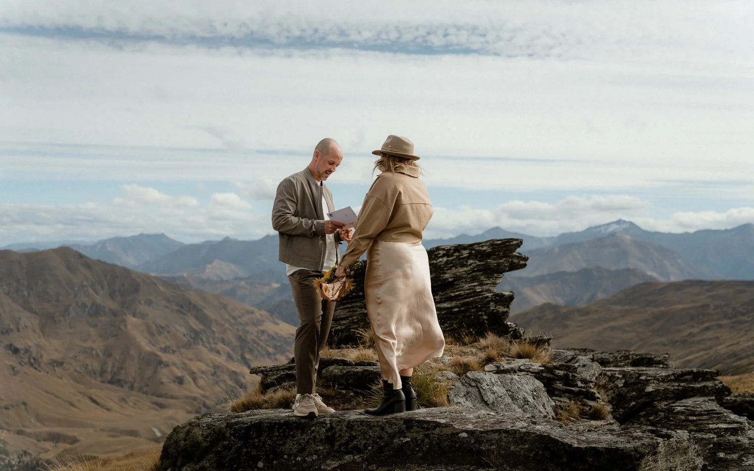 Vanguard Peak elopement wedding couple standing on top of the Queenstown mountains during their NZ elopement. 
