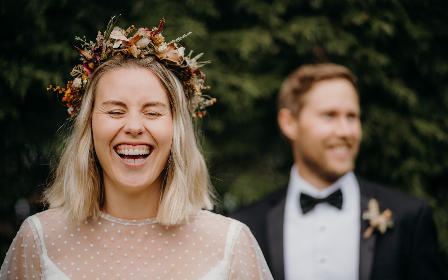 Happy bride laughing in Queenstown Gardens during elopement wedding with Wild Love Elopements