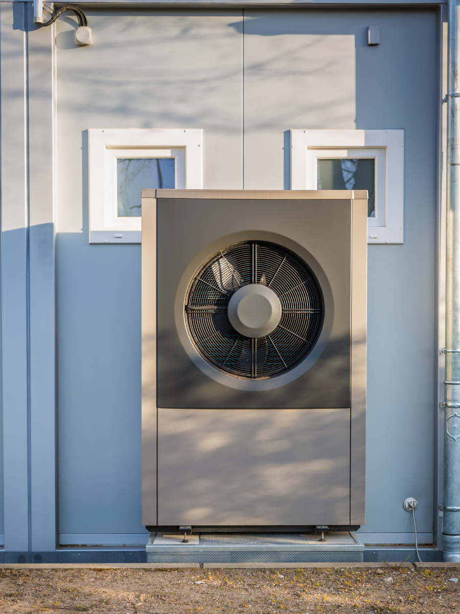Outdoor air-source heat pump installed beside a building Keep