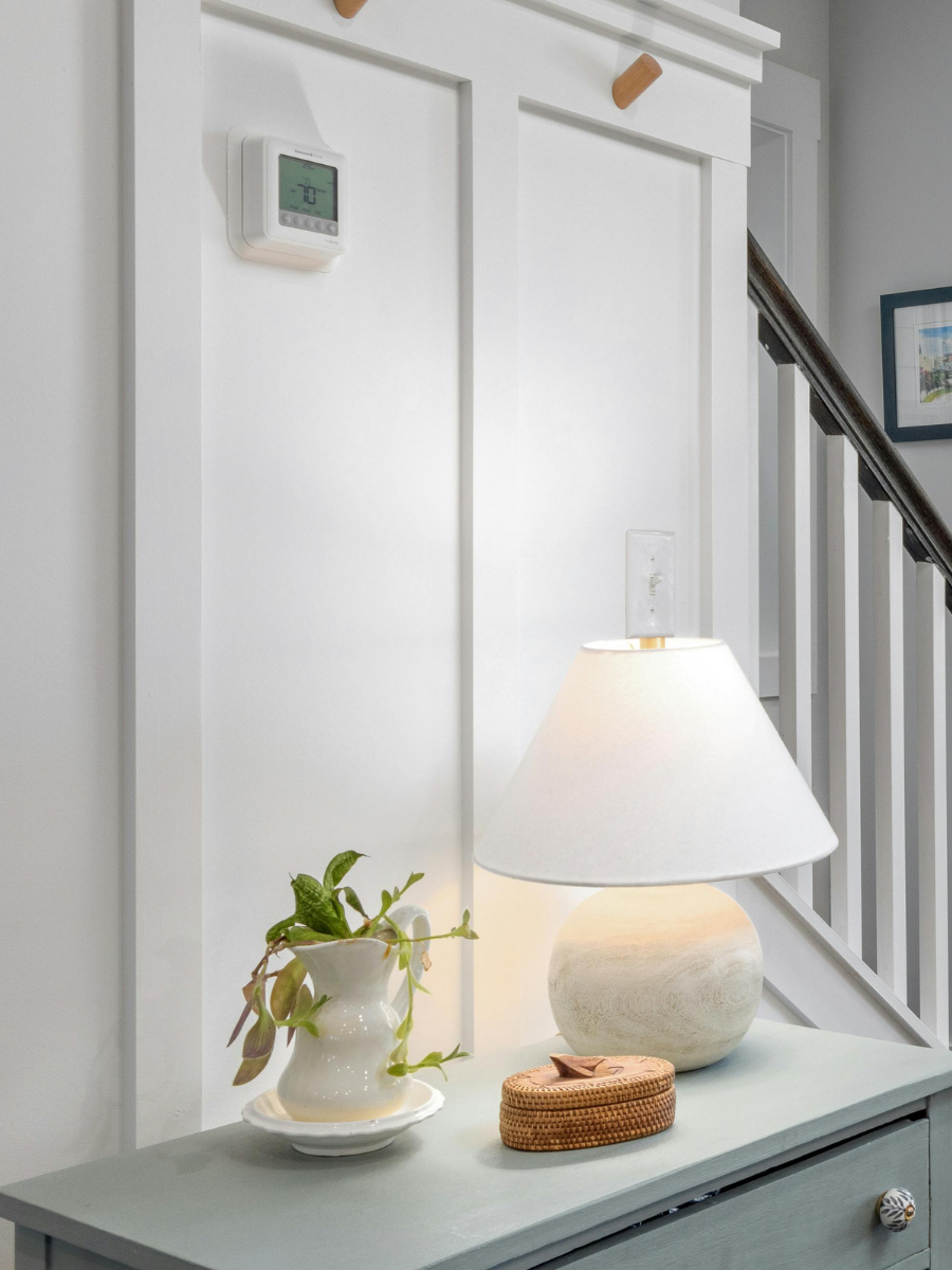 Wall-mounted thermostat controlling a residential HVAC system