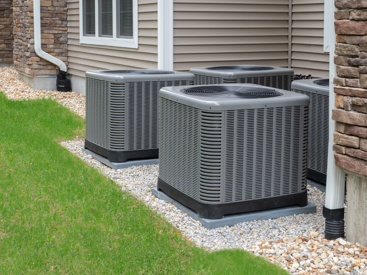 Outdoor HVAC condenser units installed beside a residential home