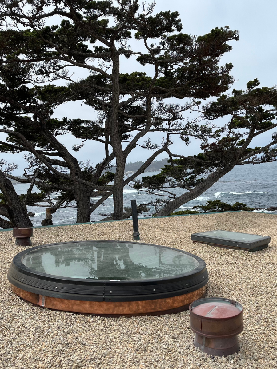 Custom round skylight with metal curb installed on a coastal roof