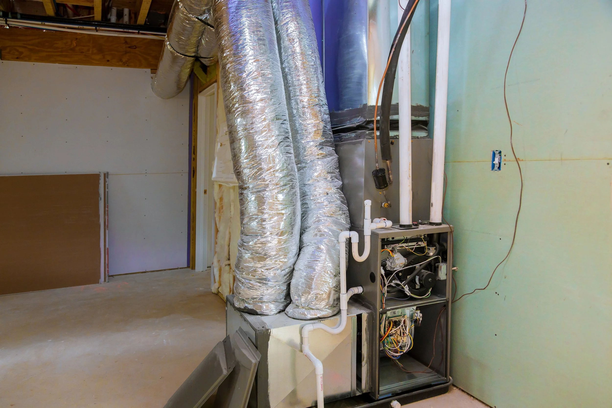 HVAC technician working on furnace control board and heating system components in Carmel Valley California
