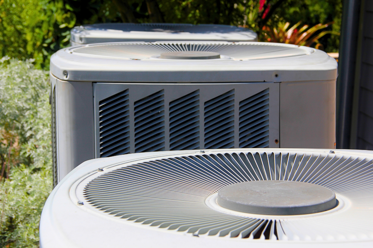 Residential air conditioning condenser units installed outside a home in Carmel Valley