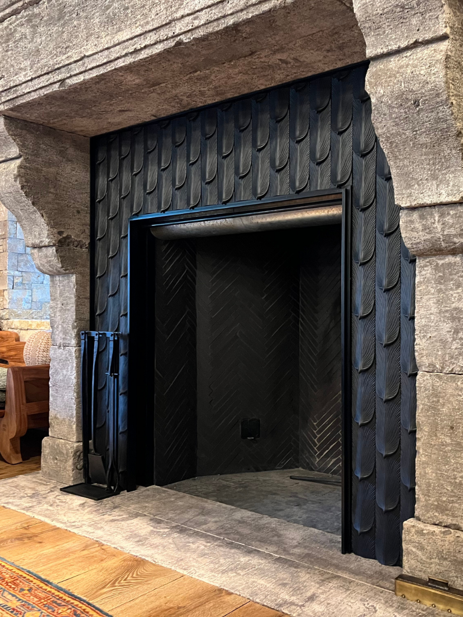 Custom black metal fireplace surround with decorative panels
