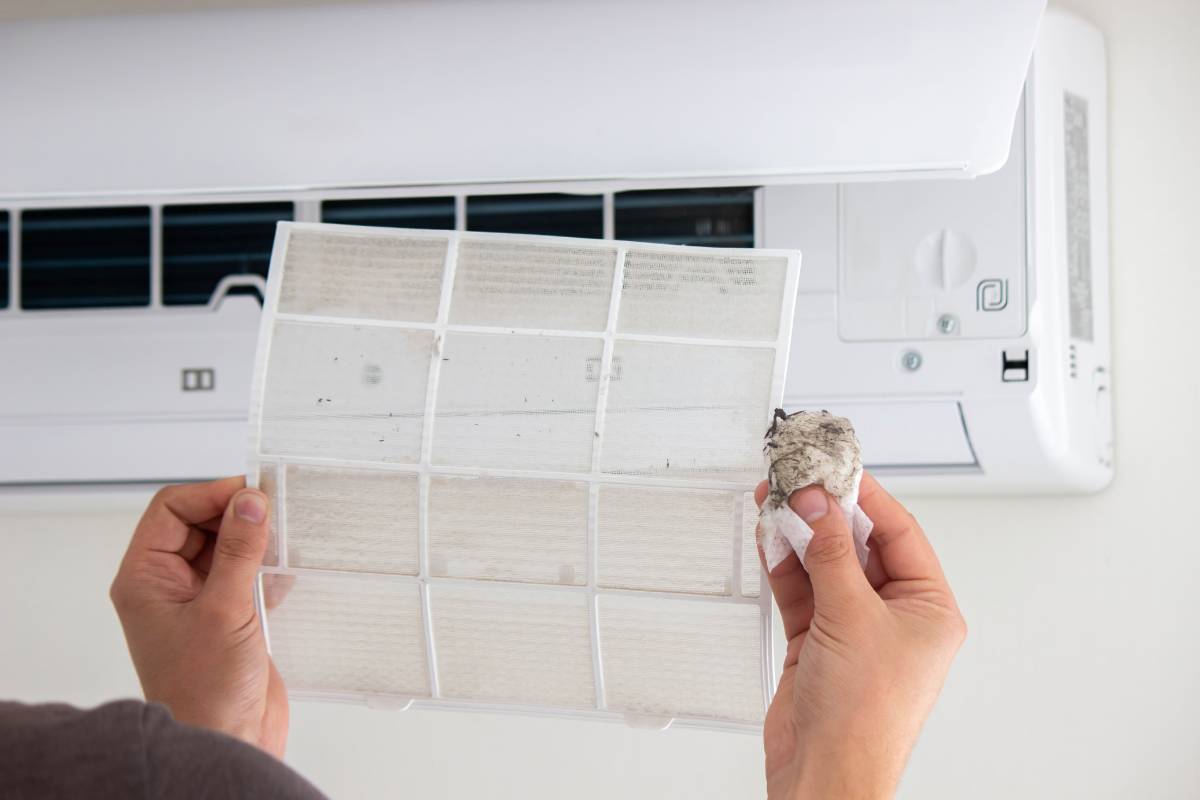 Homeowner cleaning a dirty reusable mini-split air filter
