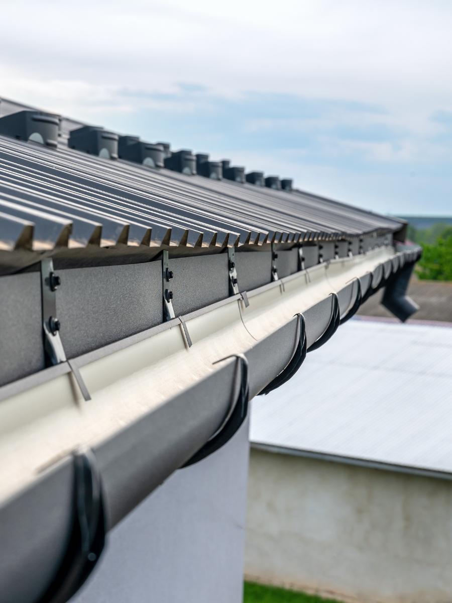 Metal gutter system installed along a residential roofline
