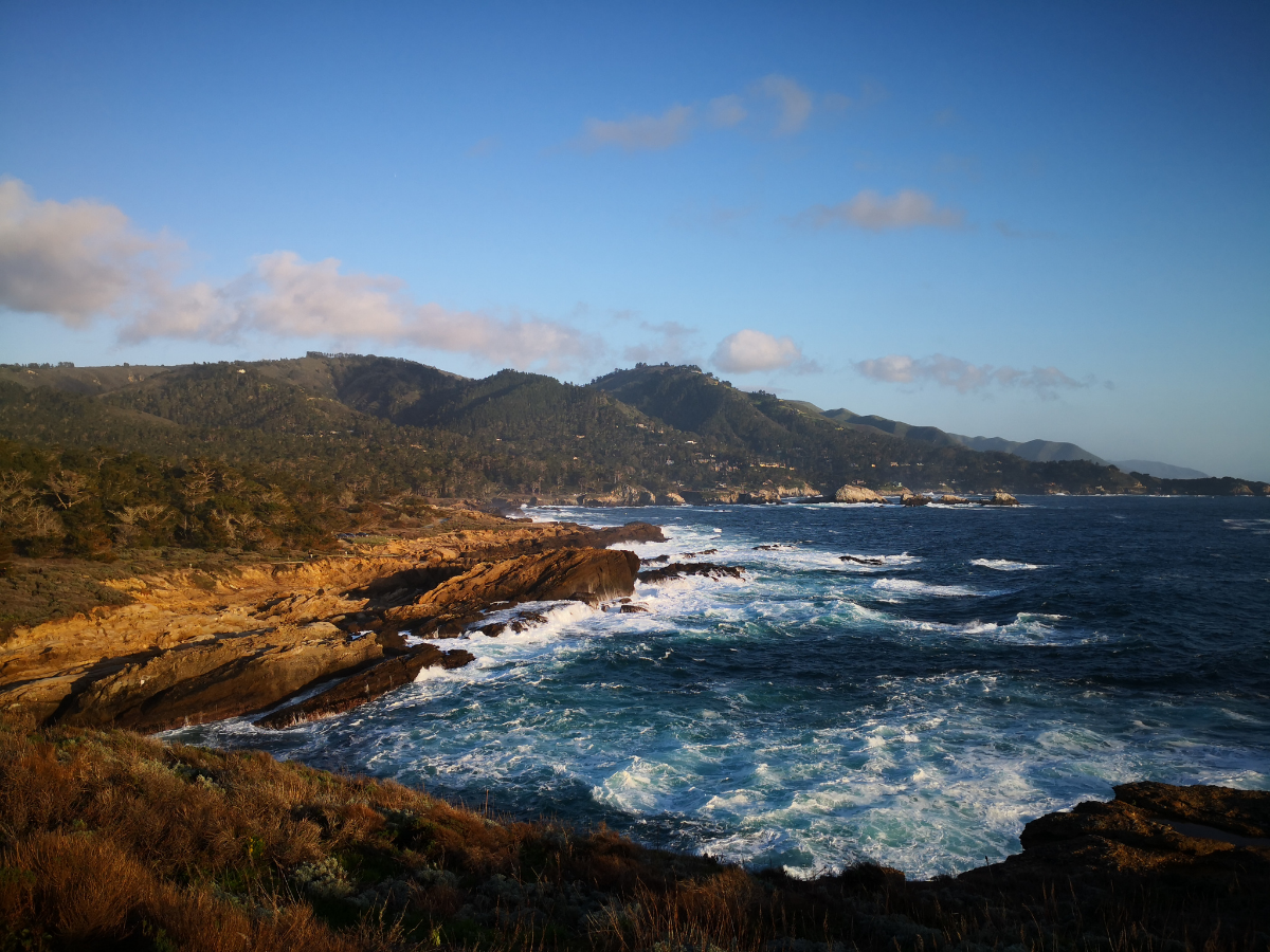 Rocky Monterey County coastline with ocean waves and coastal hills illustrating marine air exposure near homes and HVAC equipment