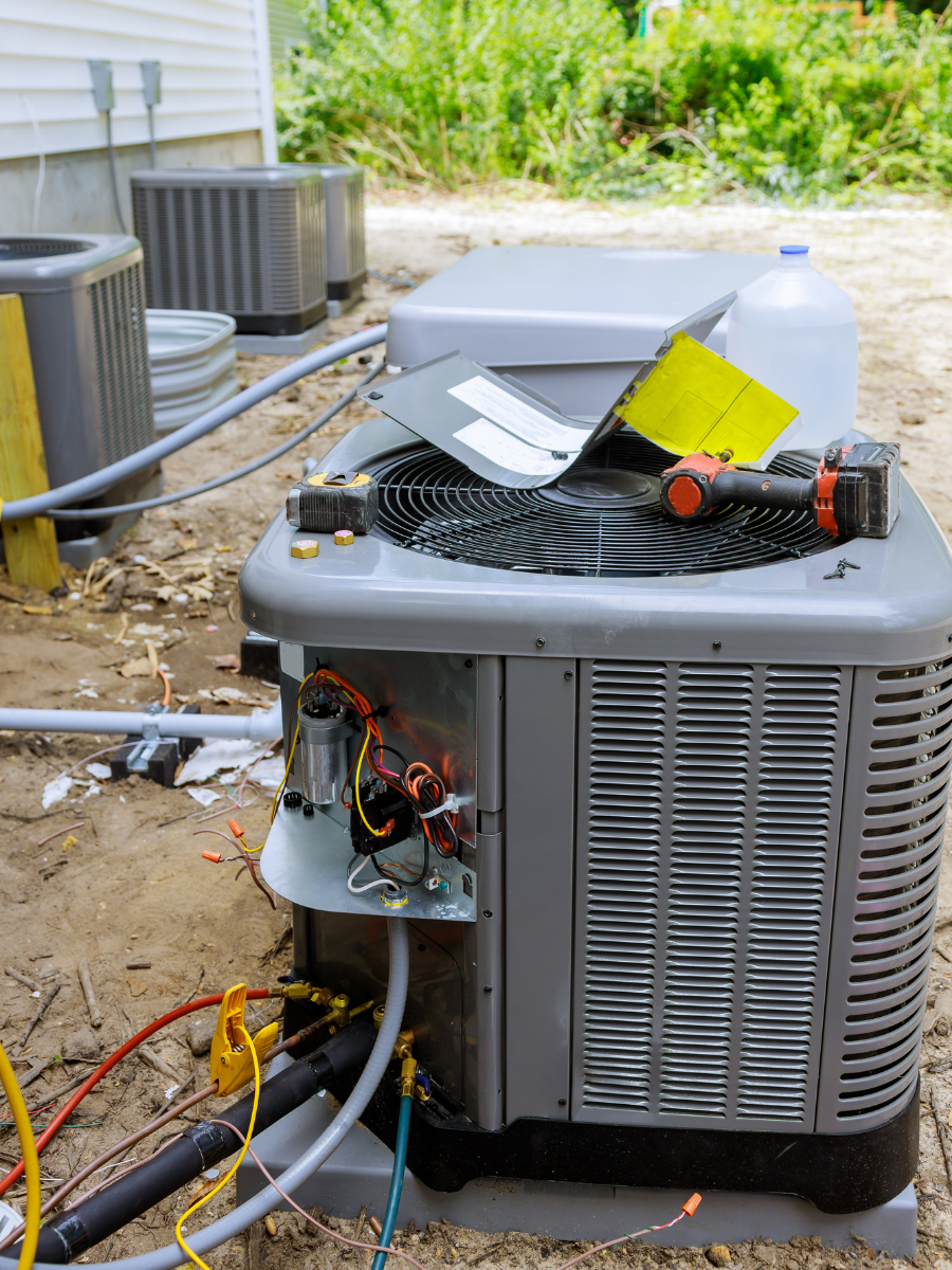 Outdoor air conditioning condenser undergoing professional repair