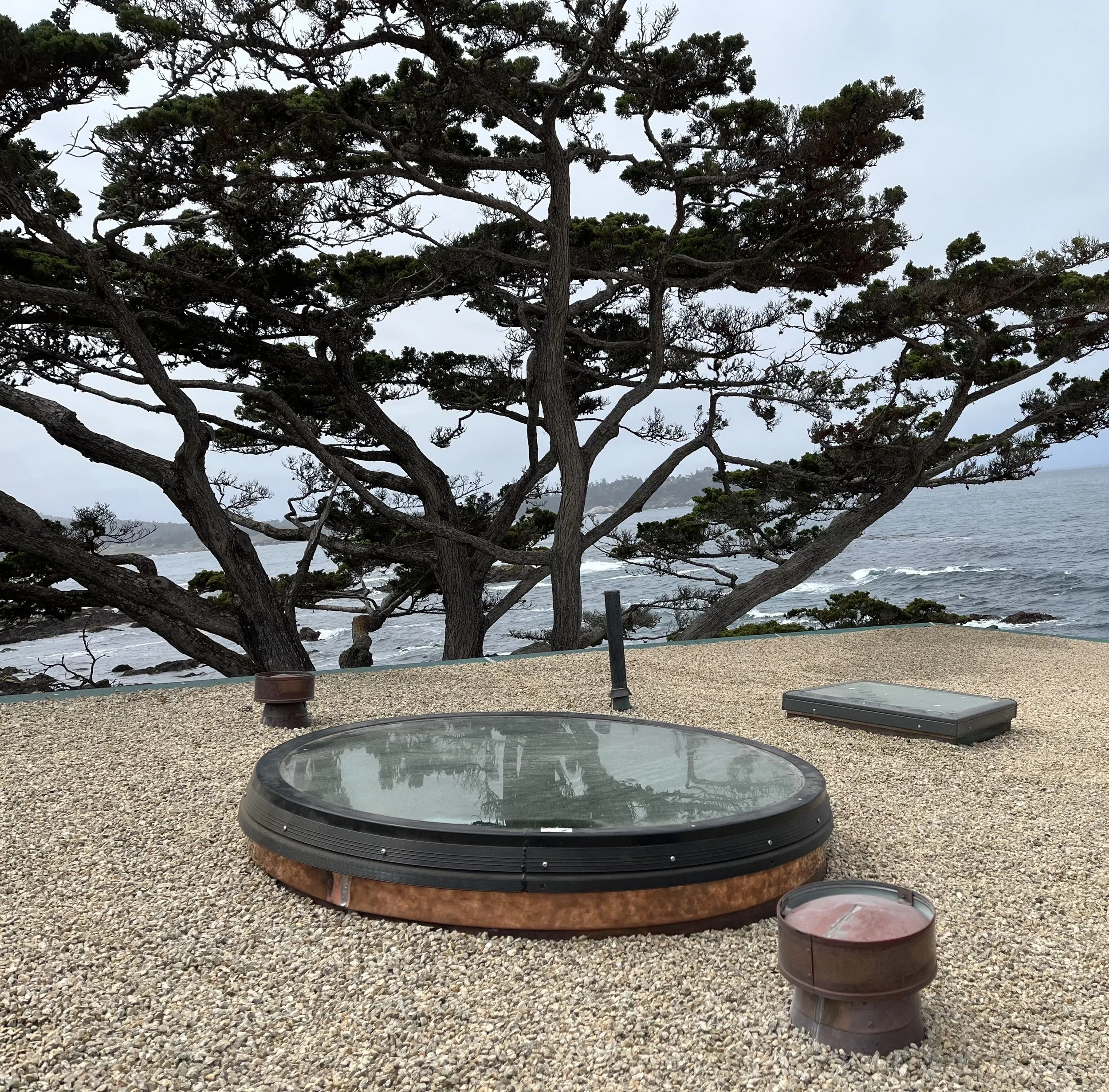Custom copper roof detail surrounding a round skylight on a coastal Monterey County home