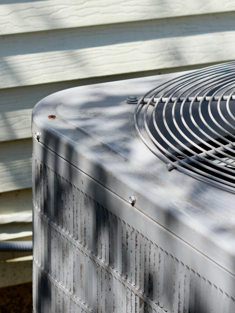 Older residential air conditioning condenser in need of service