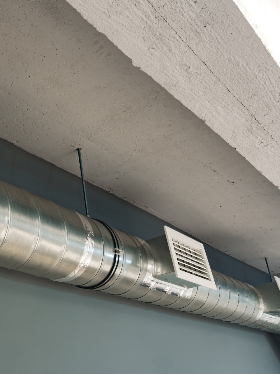 Exposed metal HVAC ductwork with an air vent