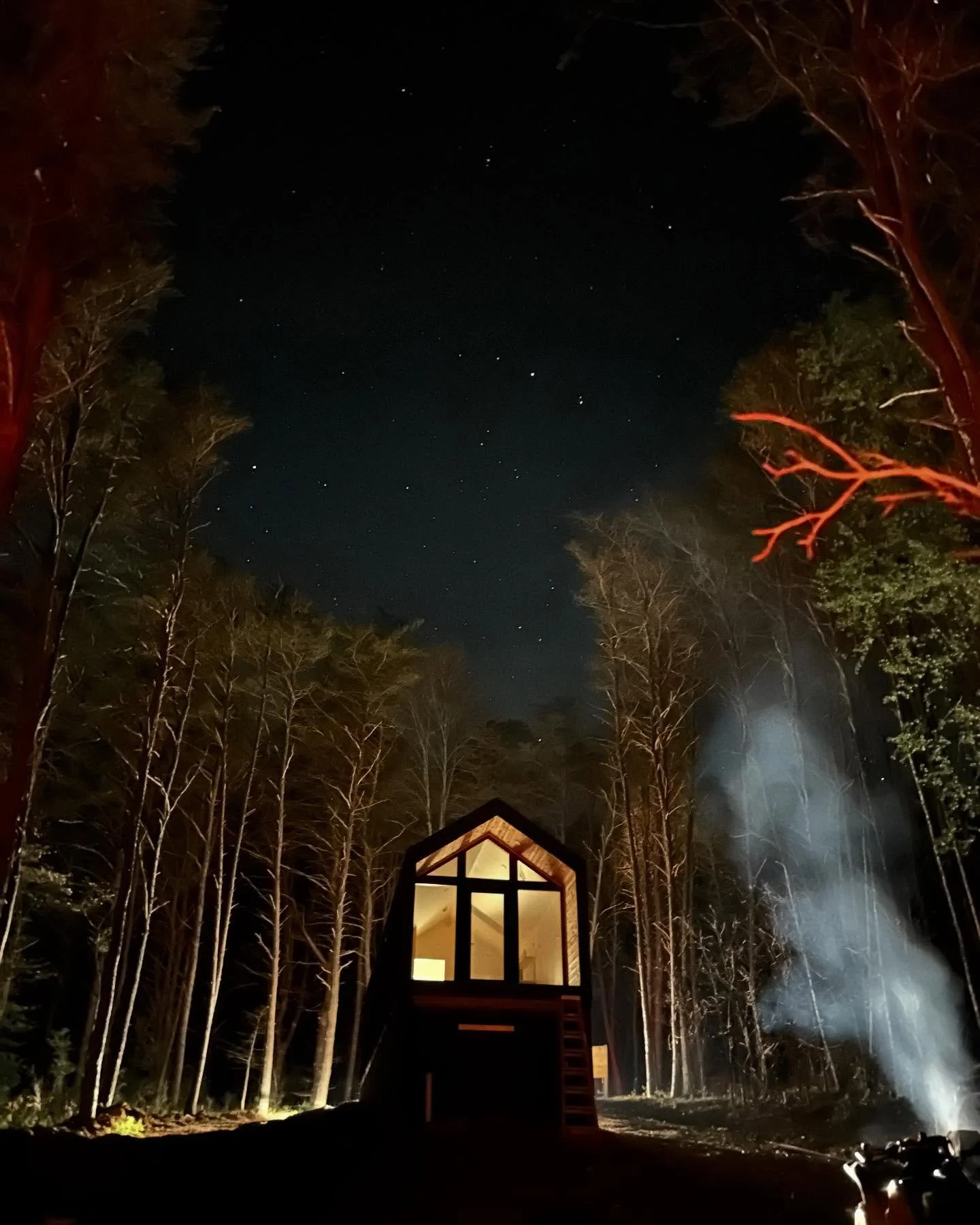 This photo was a happy accident. 🤍We had worked well into the night tending the fire we built to burn all the brush and timber from clearing the woods around the cabins. When it was finally time to pack up and head in, we realized the chainsaws were