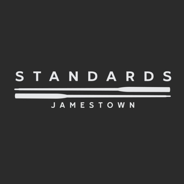 Logo for Standards Jamestown with the word 'STANDARDS' in large text, a horizontal white line beneath, and 'JAMESTOWN' in smaller text below the line, all on a black background.