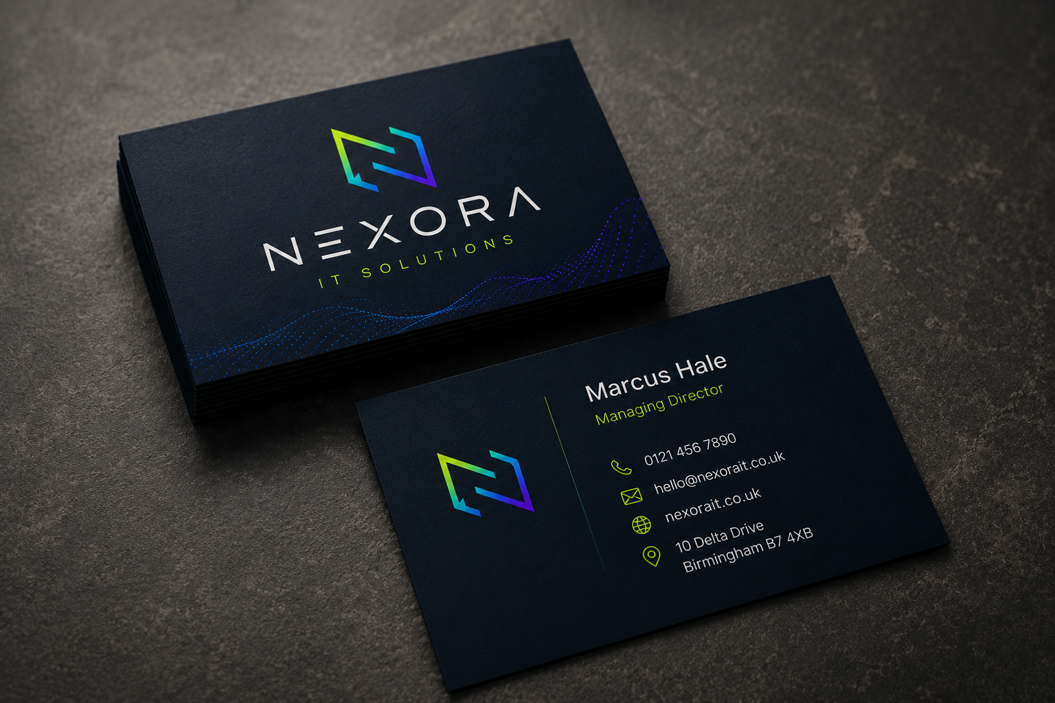 Business card for Nexora IT Solutions featuring a logo with a stylized arrow and holographic gradient colors, containing contact information for Marcus Hale, the managing director, on a dark background.