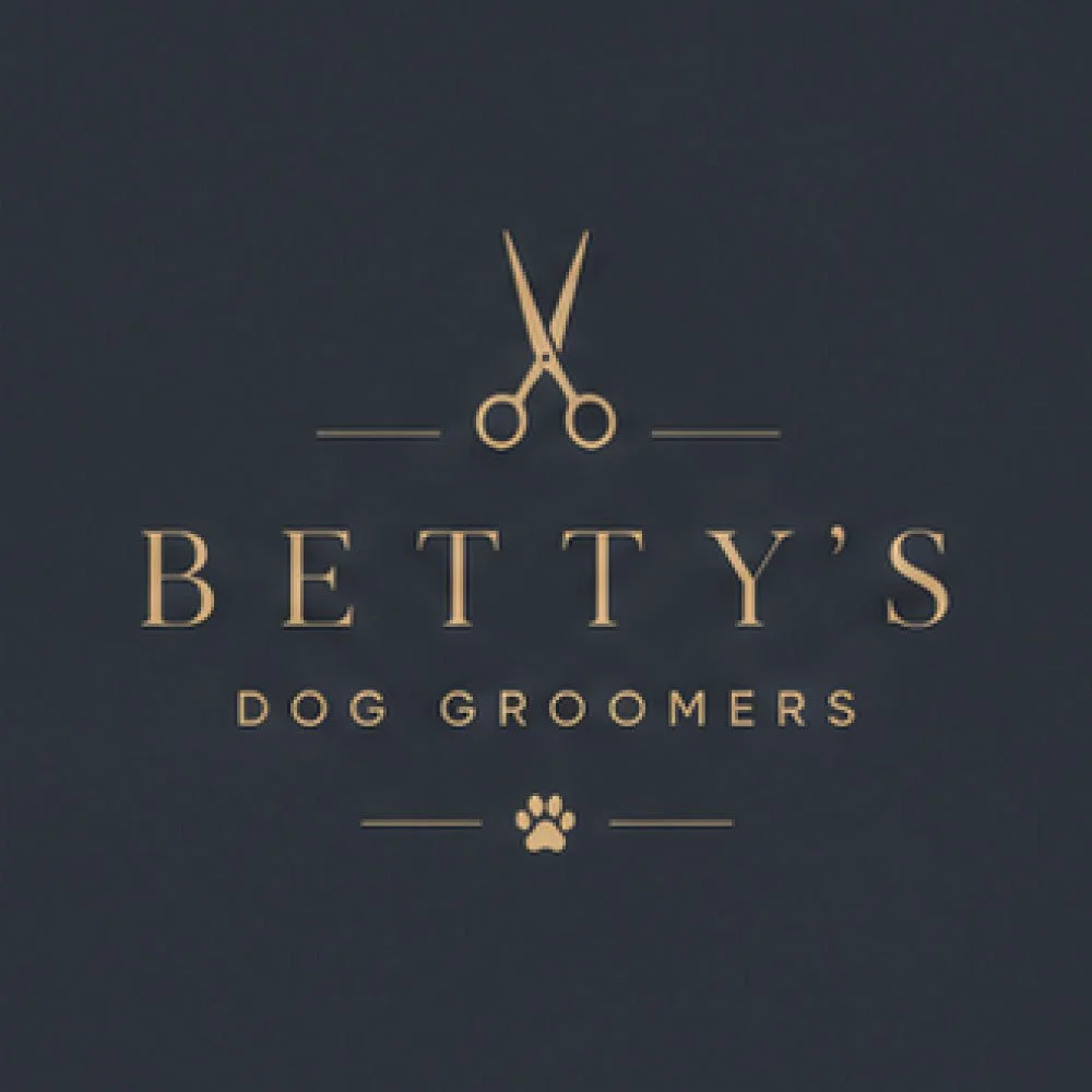 Logo for Betty's Dog Groomers with scissors and paw print.