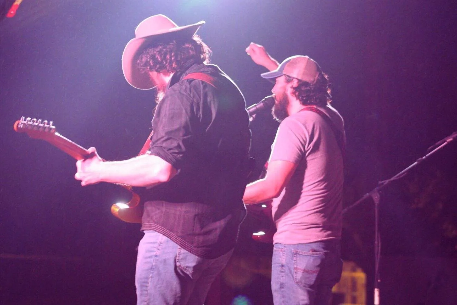 Jeff Jacobs sings under a potlight on stage