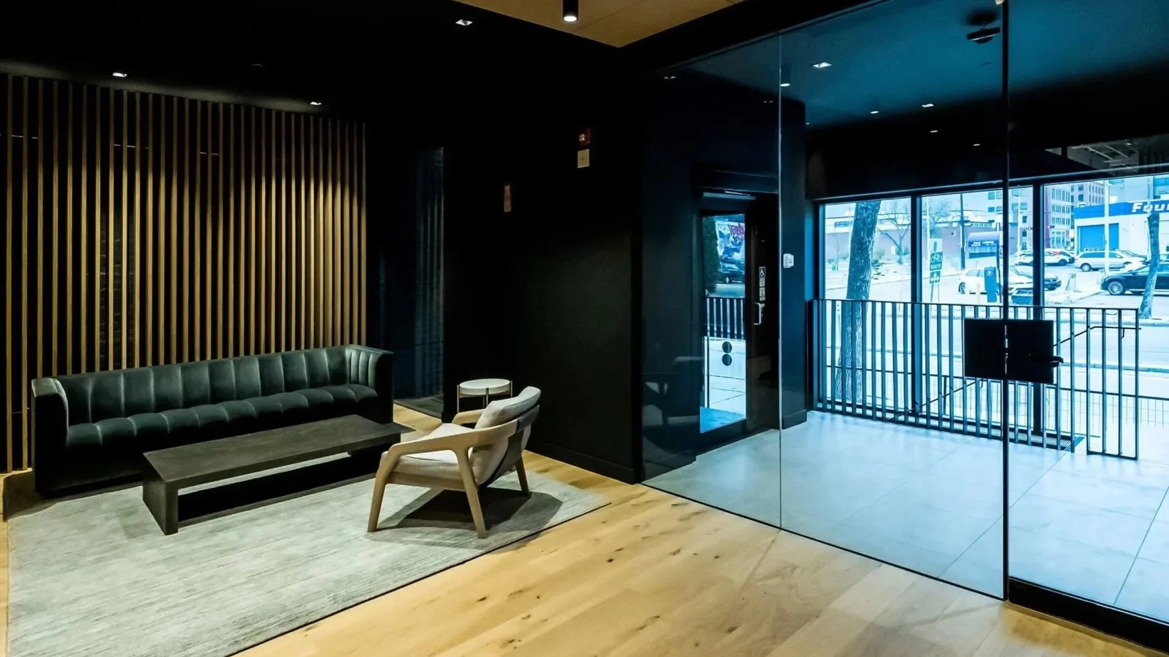 A Butler Mobility - RAM Stratus Elevator in a modern commercial building featuring a glass foyer and a seating area