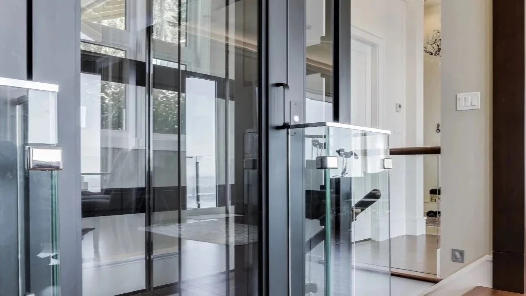 A close up detail of a Butler Mobility - RAM Stratus Elevator highlighting the modern sleek glass design