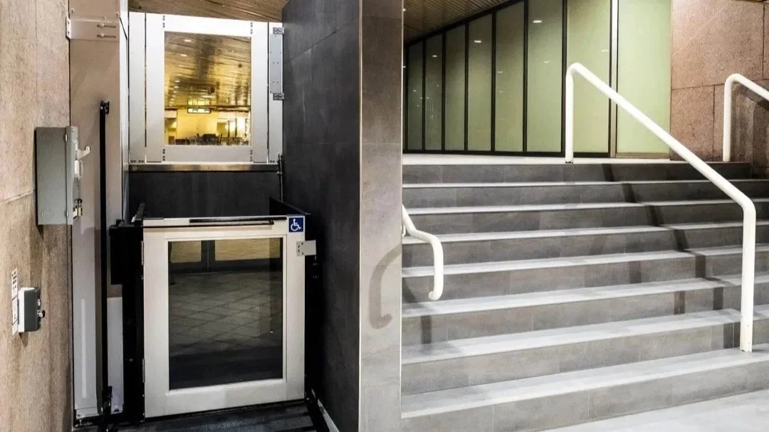 Butler Mobility - RAM Trus-T vertical platform lift next to staircase at a commercial building