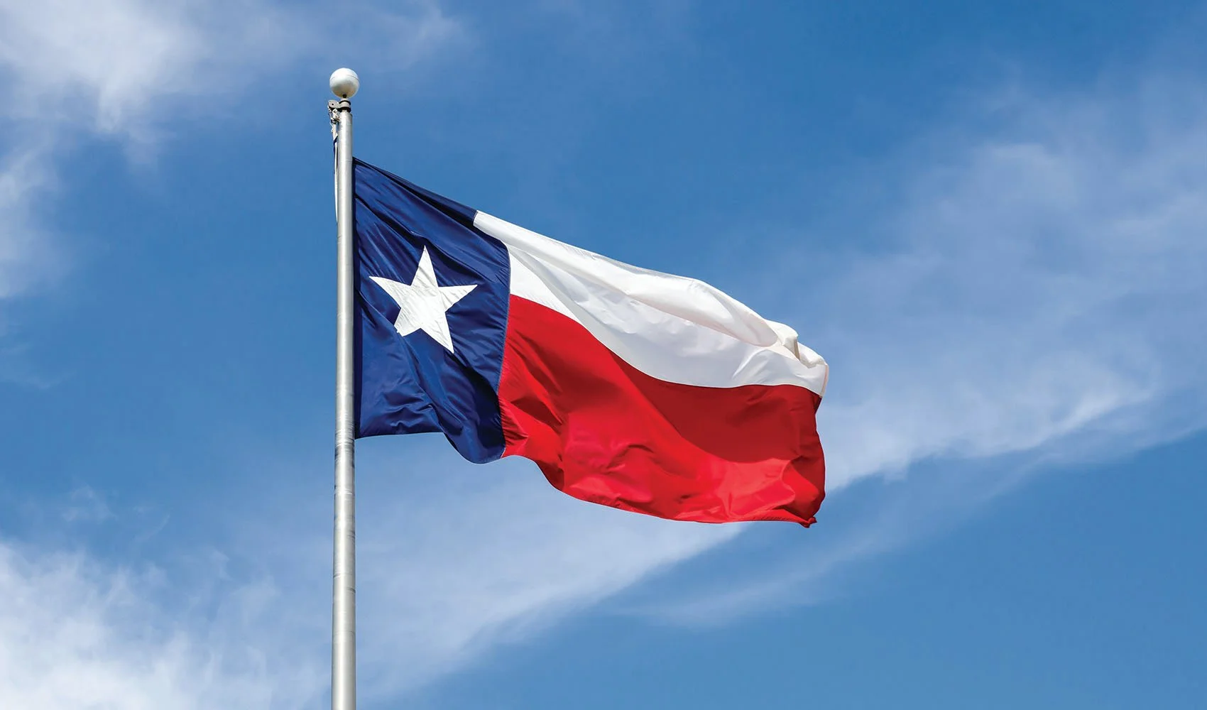 Butler Mobility Branch in Houston Texas  with state flag blowing in the wind on a sunny day with a blue sky