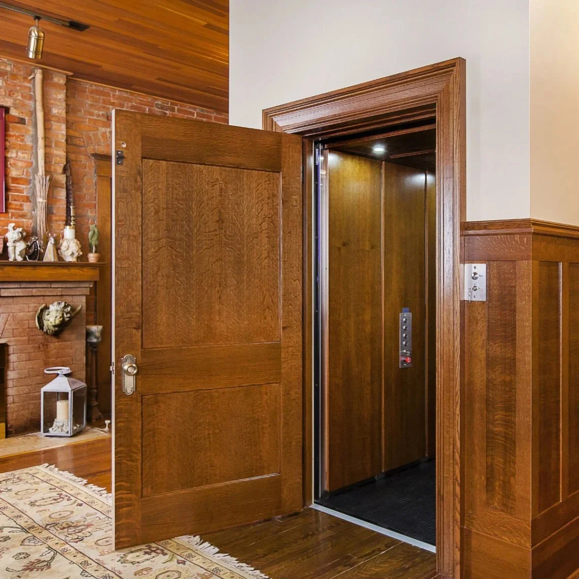 A Butler Mobility - RAM Crystal Elevator in a residential living room featuring a wood door and wood interior