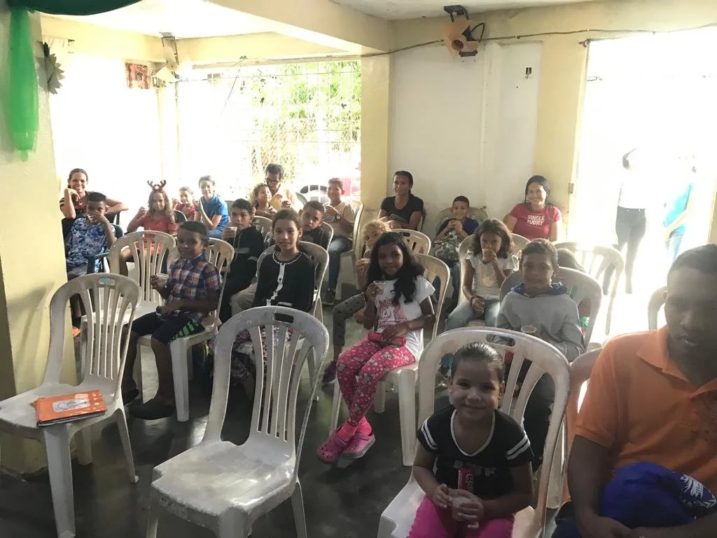 Kids sitting and waiting to hear about the Lord!