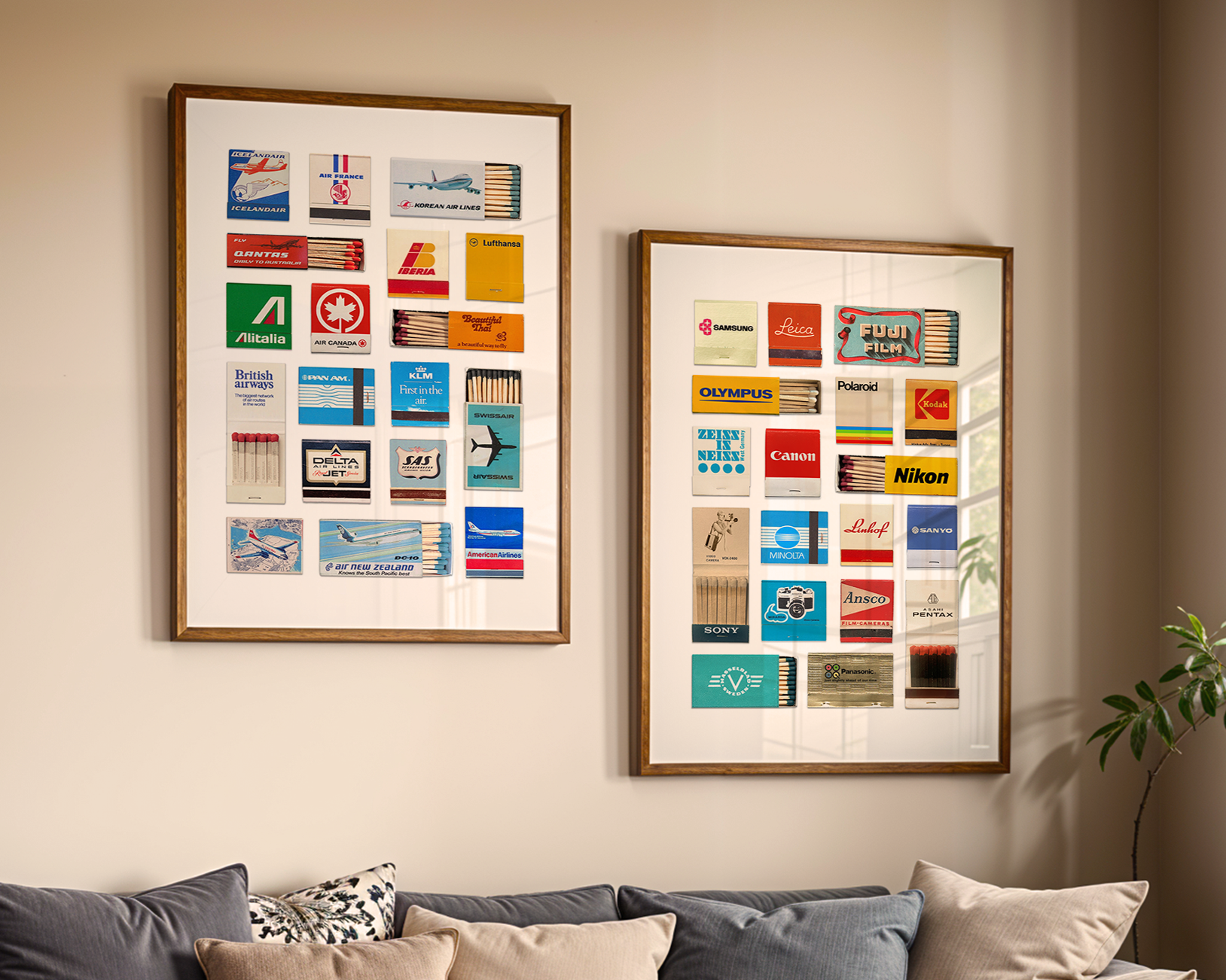 Two framed art pieces on a beige wall featuring vintage airline and camera logos and matchbook designs, with a gray sofa and white cushions below.