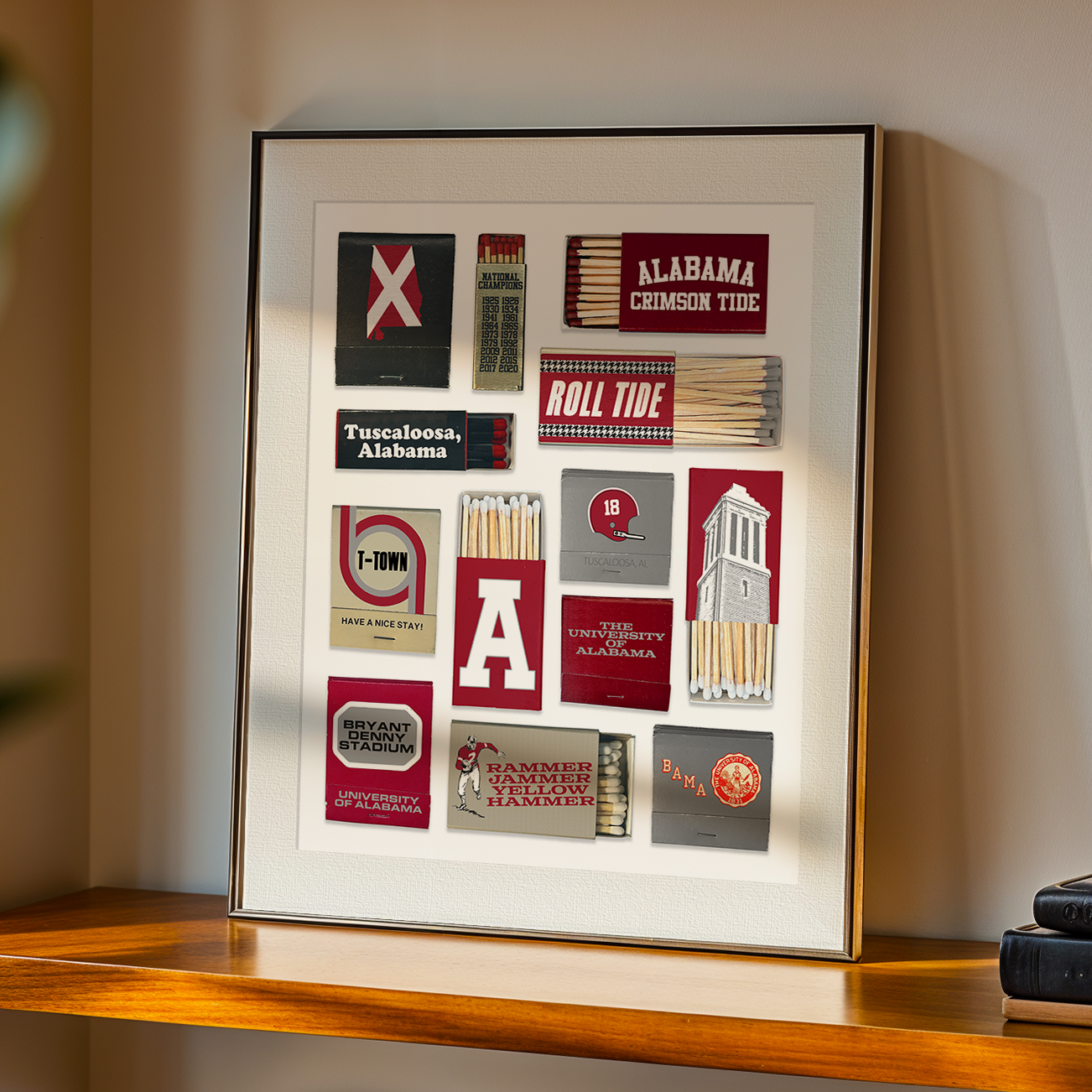 Framed collage of Alabama Crimson Tide-themed matches, patches, and memorabilia on a wall, including team logos, stadium references, and state symbols.