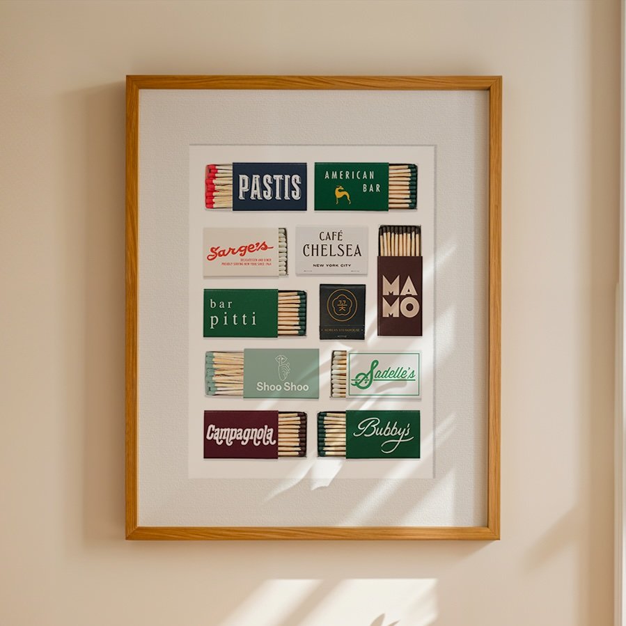 Artwork featuring various matchbox covers with different brands and designs, framed on a wall.