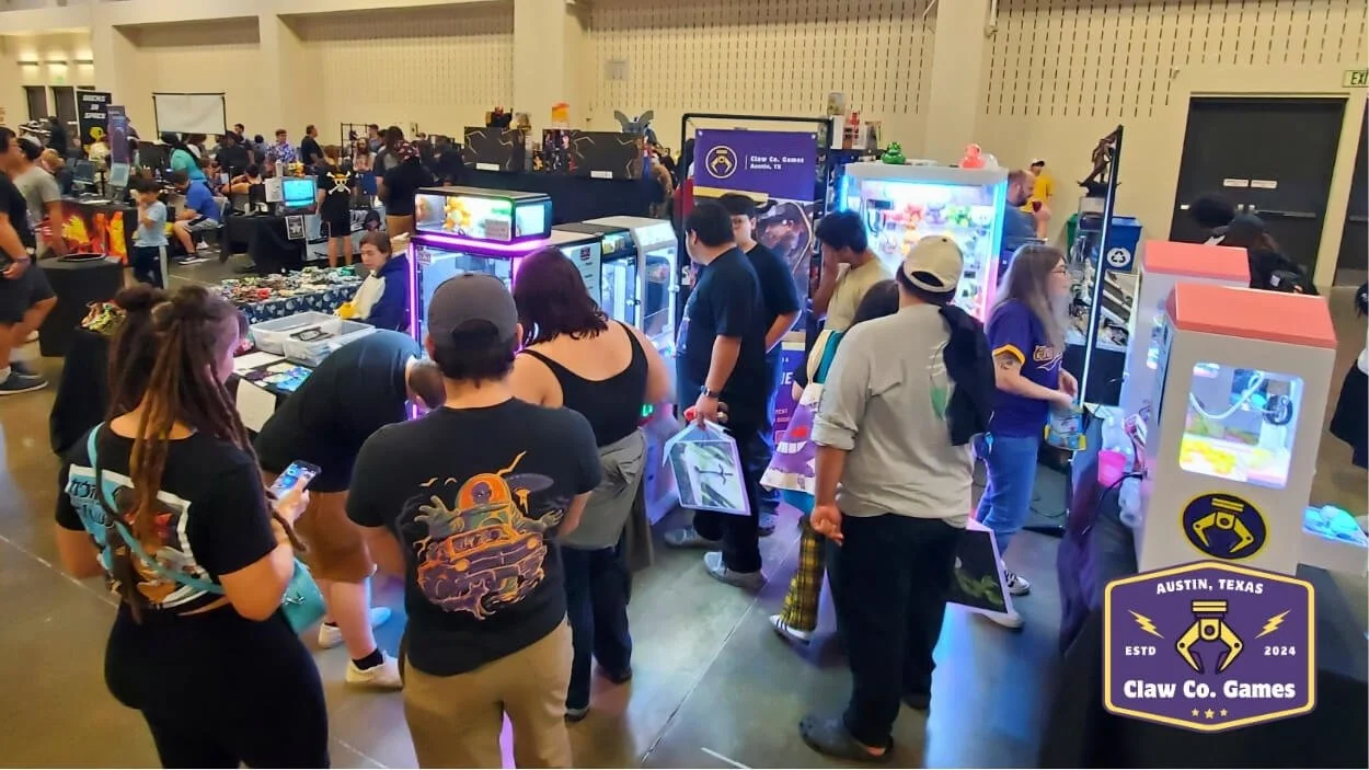 A crowd of people gathered around the Claw Co. Games mini arcade at the 2025 Classic Game Fest.