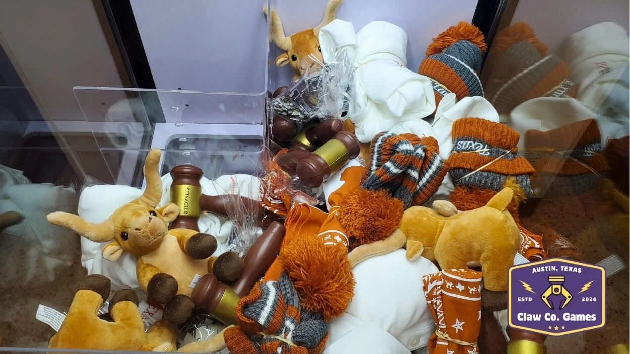 The team at the School of Law at the University of Texas wanted to add a fun twist to their alumni reunion event by incorporating some school spirit with a claw machine rental.