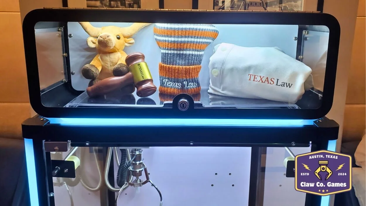 The team at the School of Law at the University of Texas wanted to add a fun twist to their alumni reunion event by incorporating some school spirit with a claw machine rental.