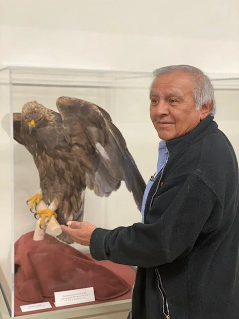 Larson Bill stands next to a golden eagle.