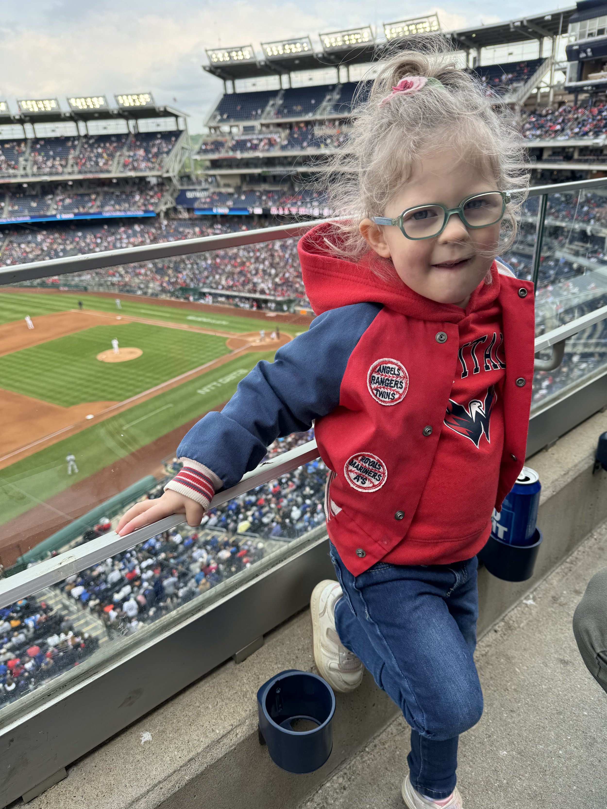 Wearing her daddy's vintage jacket at the Nationals game
