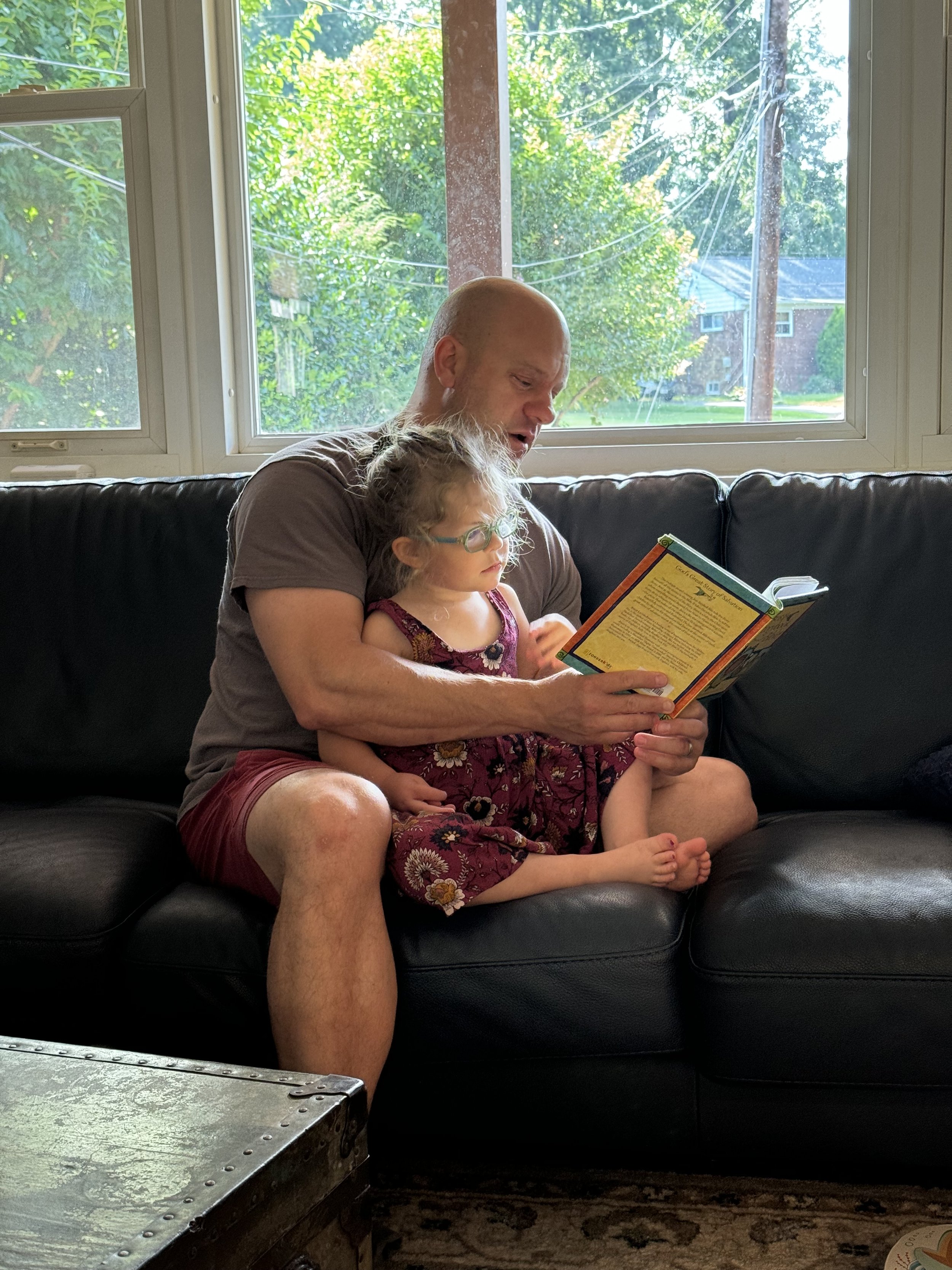 Sometimes she sits still for Daddy to read to her