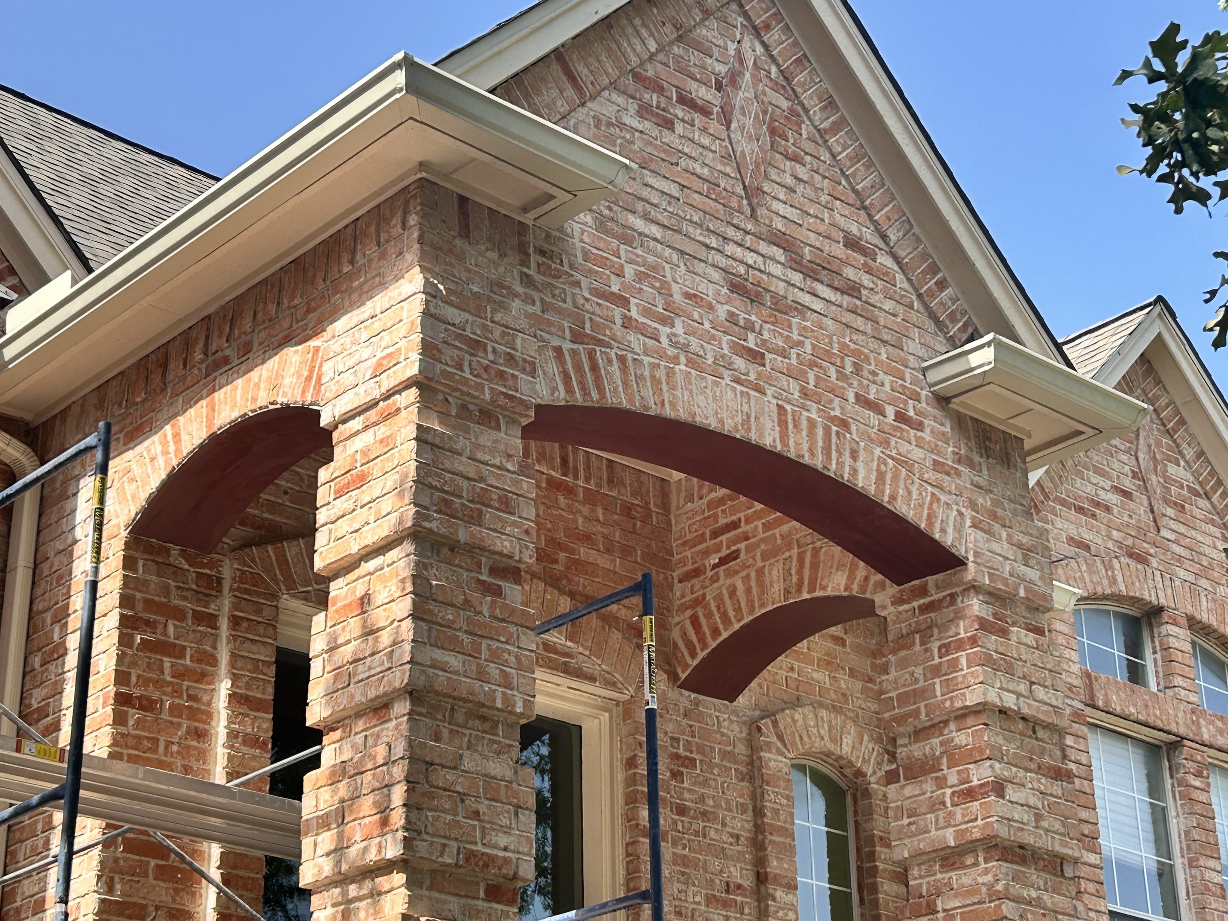 Triple brick archway reconstruction with structural steel support and rebuilt masonry