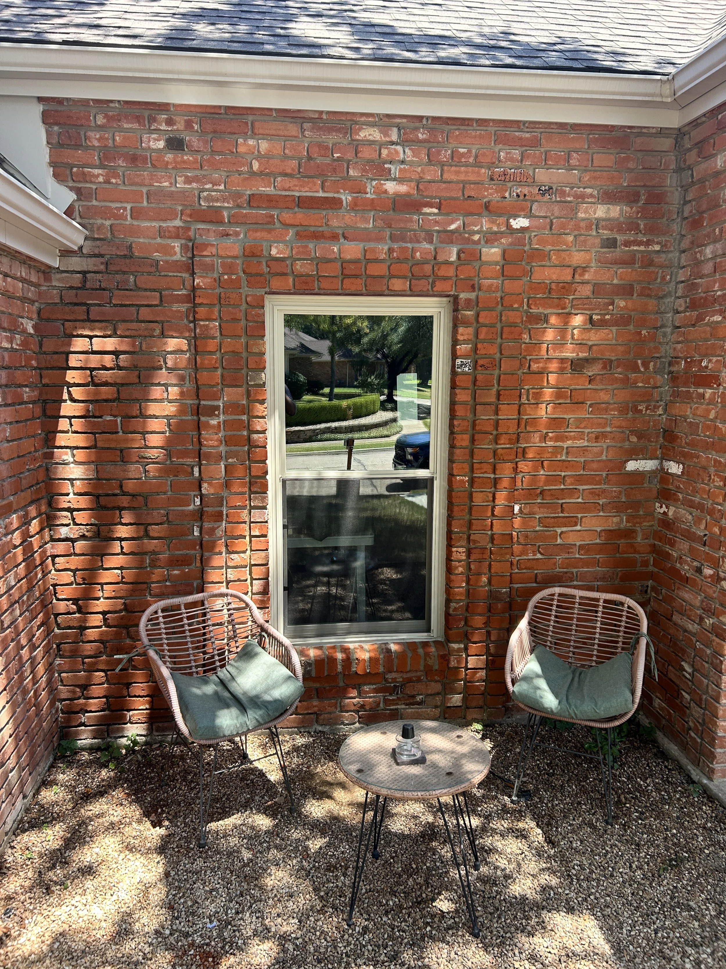 Arched window opening converted to a square-top window with brick masonry reconstruction
