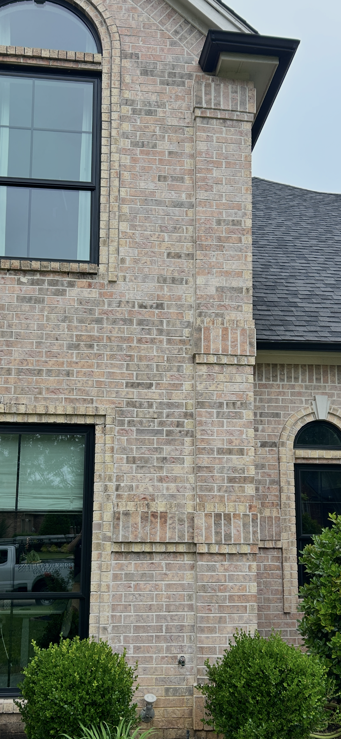 Full-height brick corner sealant repair on exterior masonry wall