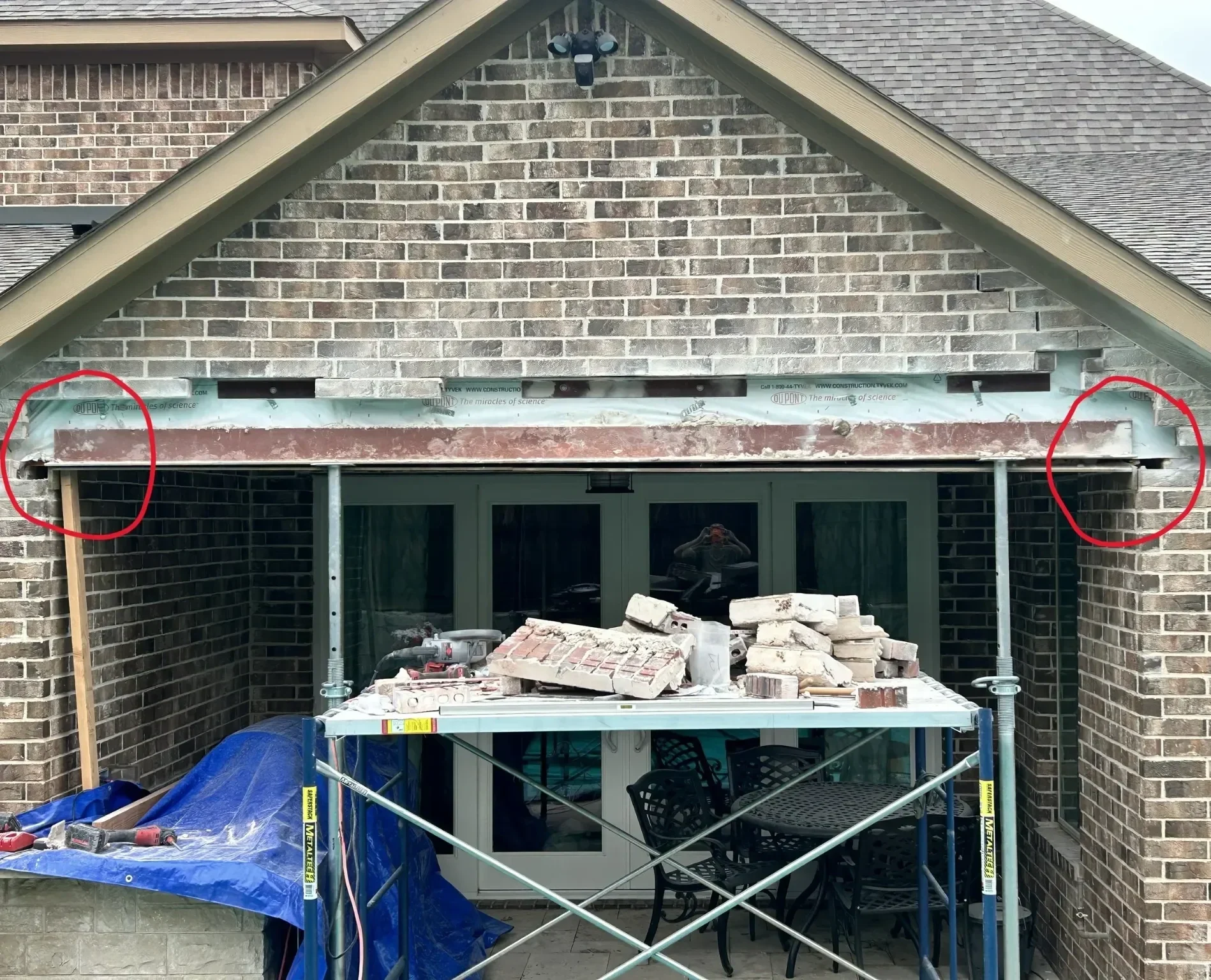 Undersized steel lintel above a brick walkway opening showing failure and masonry movement