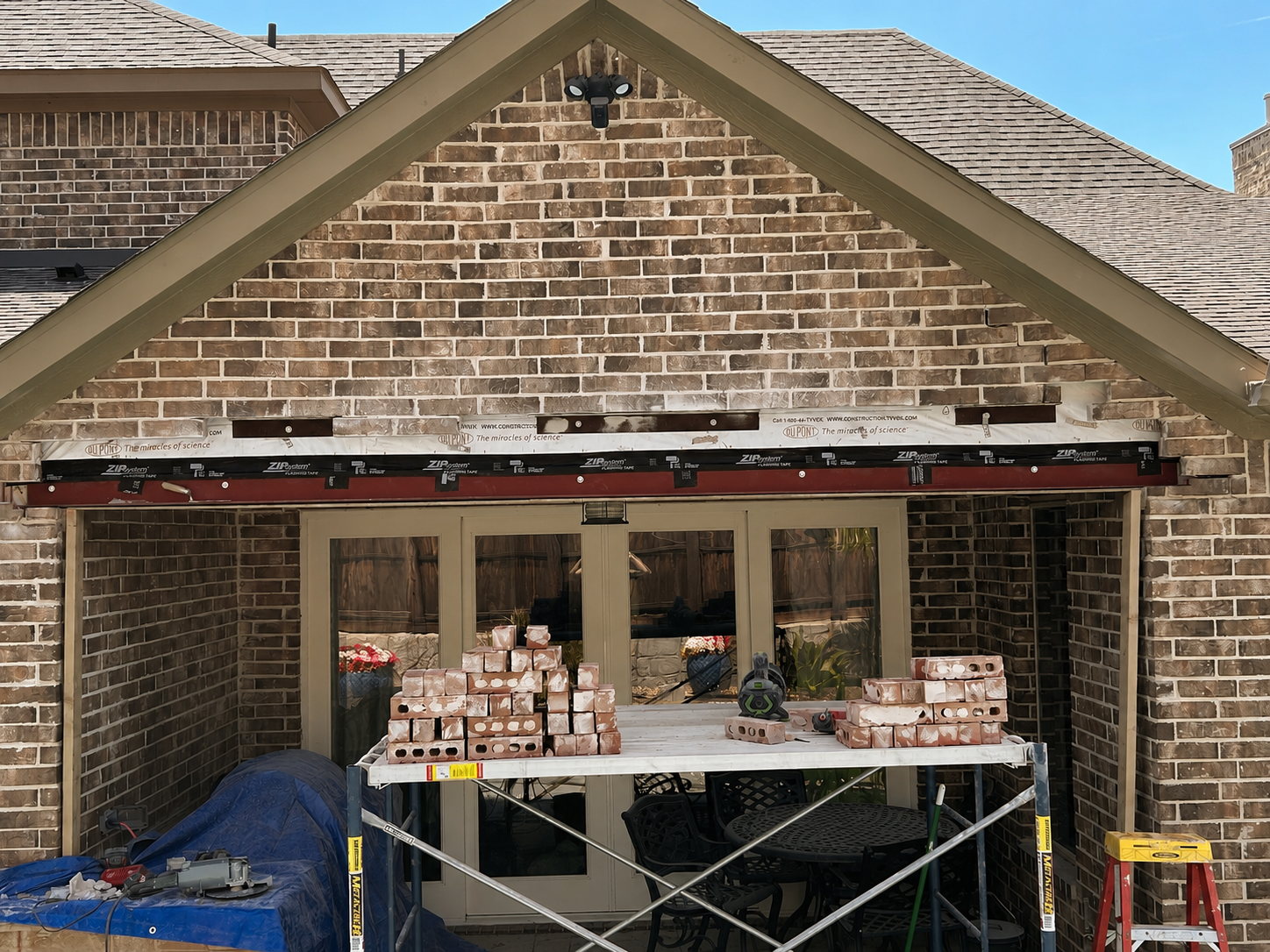 New properly sized steel lintel installed above a brick walkway opening during structural masonry repair