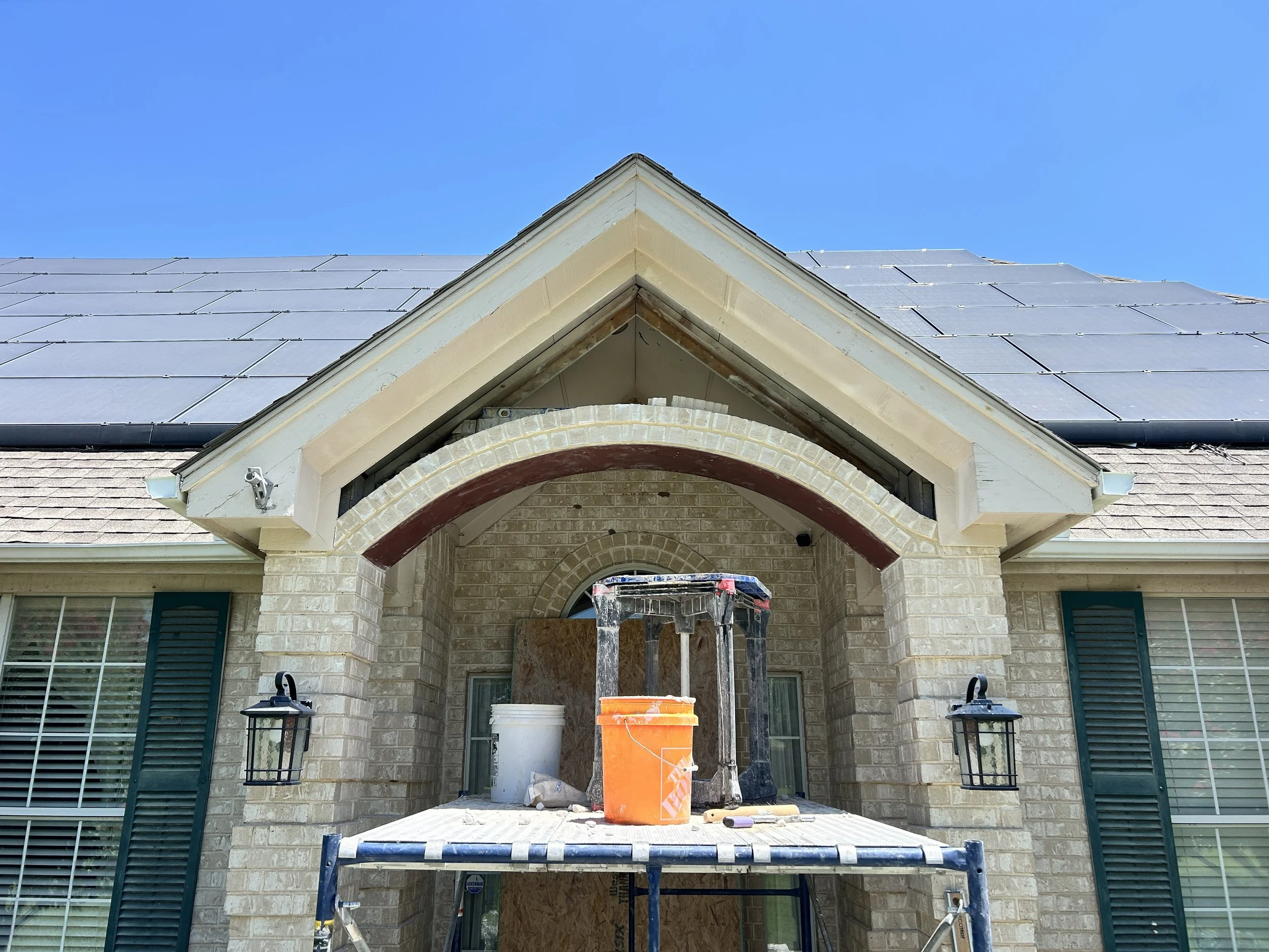 Custom steel support installed for brick archway reconstruction with masonry rebuild in progress