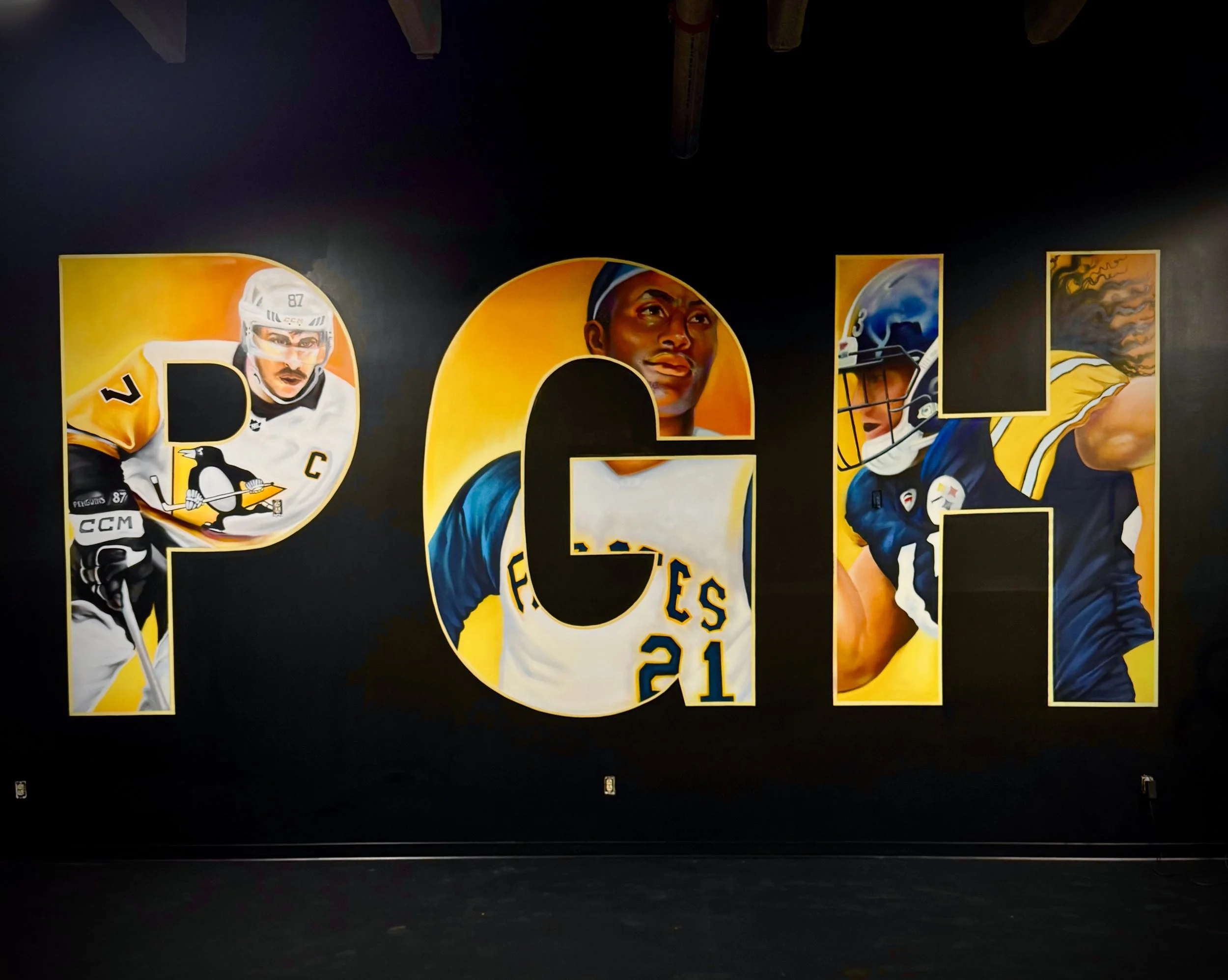 Colorful artwork on a wall featuring portraits of hockey players in various uniforms.