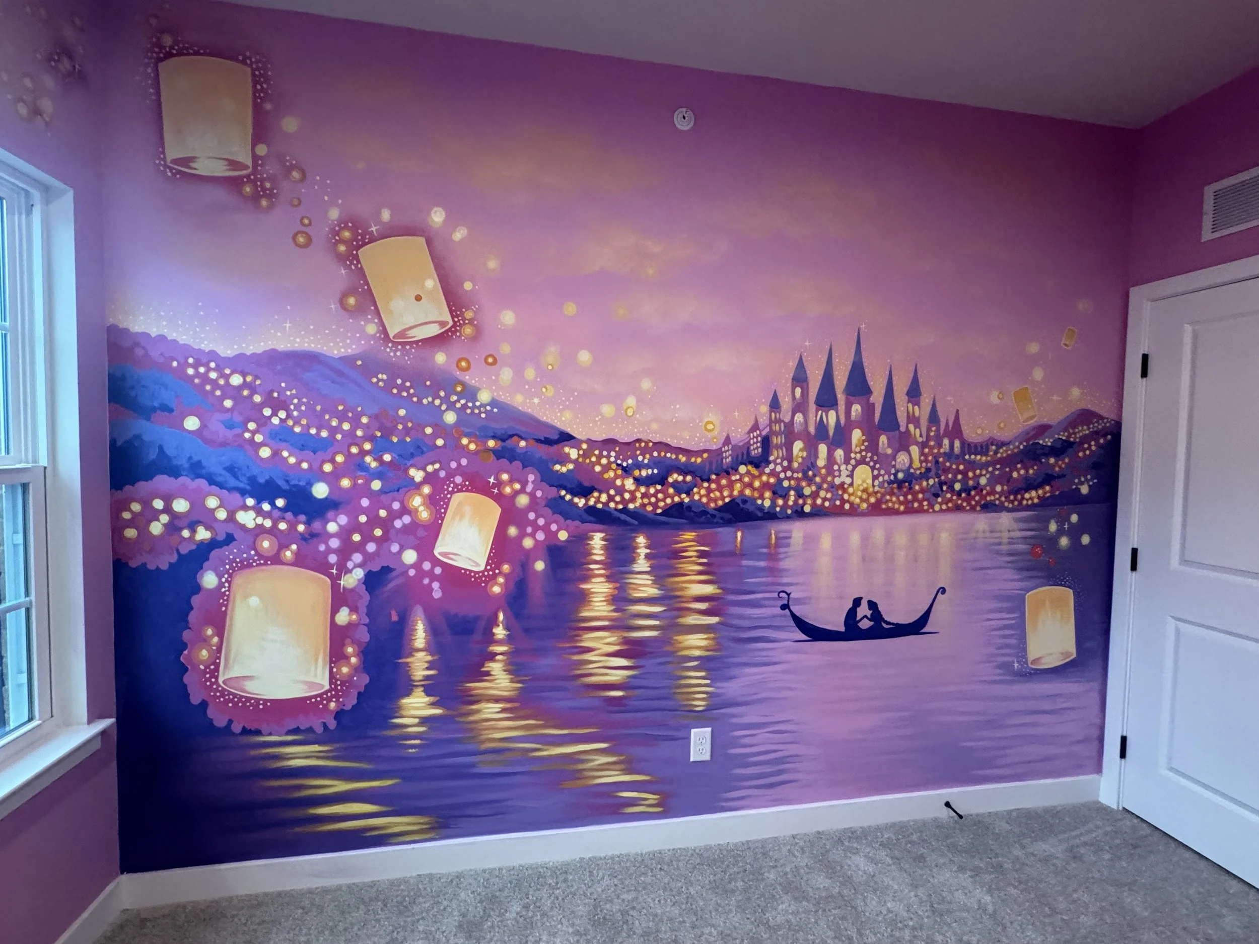 A large pink fantasy mural on a wall featuring a castle, floating lanterns, and a waterfall scene with glowing lights and stars, creating a magical landscape.